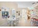 Casual breakfast nook with white table and chairs near kitchen at 4821 Hanging Moss Ln, Sarasota, FL 34238