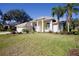 One-story house with beige exterior and palm trees at 4821 Hanging Moss Ln, Sarasota, FL 34238