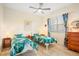 Bright guest bedroom with two twin beds and leafy bedding at 4821 Hanging Moss Ln, Sarasota, FL 34238