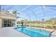 Relaxing screened pool with view of backyard and lake at 4821 Hanging Moss Ln, Sarasota, FL 34238