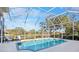 Screened pool and patio with lake view and seating at 4821 Hanging Moss Ln, Sarasota, FL 34238