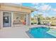 Covered patio with sliding glass doors leading to living room and pool at 4821 Hanging Moss Ln, Sarasota, FL 34238