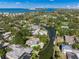 Aerial view of a waterfront property with mature trees and a canal at 4857 Primrose Path, Sarasota, FL 34242