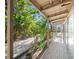 Covered porch overlooking a lush, tropical landscape at 4857 Primrose Path, Sarasota, FL 34242