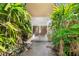 Inviting entryway with glass doors and lush landscaping at 4857 Primrose Path, Sarasota, FL 34242