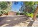 Two-car garage with light-colored exterior and mature trees at 4857 Primrose Path, Sarasota, FL 34242