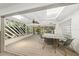 Relaxing screened porch with dining area and ceiling fan at 4857 Primrose Path, Sarasota, FL 34242