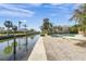 Peaceful waterfront lot with canal access and a glimpse of a pool at 4857 Primrose Path, Sarasota, FL 34242