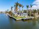 Aerial view of waterfront home with private dock and lush landscaping at 512 Bayview Pl, Anna Maria, FL 34216