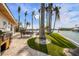 Outdoor kitchen, dining area, and lush landscaping highlight this expansive backyard at 512 Bayview Pl, Anna Maria, FL 34216