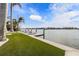 Private backyard oasis with a dock and lounge chairs at 512 Bayview Pl, Anna Maria, FL 34216