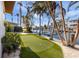 Landscaped backyard with putting green and waterfront access at 512 Bayview Pl, Anna Maria, FL 34216