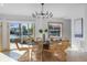 Bright dining room with water views and wicker chairs at 512 Bayview Pl, Anna Maria, FL 34216