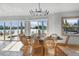 Bright dining room with water views and wicker chairs at 512 Bayview Pl, Anna Maria, FL 34216