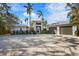 Front view of a contemporary home with a two car garage at 512 Bayview Pl, Anna Maria, FL 34216