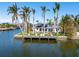 Waterfront home exterior, featuring a dock and solar panels at 512 Bayview Pl, Anna Maria, FL 34216