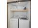 Convenient laundry room with washer, dryer, and shelving at 512 Bayview Pl, Anna Maria, FL 34216