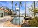 Freeform pool and spa with stone coping and serene water feature at 512 Bayview Pl, Anna Maria, FL 34216