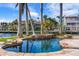 Inviting freeform pool with stone surround and lush landscaping at 512 Bayview Pl, Anna Maria, FL 34216