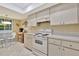 Kitchen with white appliances and breakfast nook at 5248 Marshfield Ln # 2, Sarasota, FL 34235