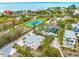 Aerial view of beachfront property with pool and tennis court nearby at 541 Edlee Ln, Longboat Key, FL 34228