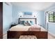 Serene bedroom with light blue walls, king-size bed and ocean-themed art at 541 Edlee Ln, Longboat Key, FL 34228