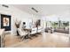 Modern dining room with glass table, white chairs, and hardwood floors at 541 Edlee Ln, Longboat Key, FL 34228