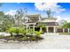 Modern two-story home with tropical landscaping and a gravel driveway at 541 Edlee Ln, Longboat Key, FL 34228