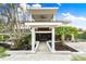 Two-story home with modern design, tropical landscaping, and walkway at 541 Edlee Ln, Longboat Key, FL 34228