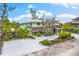 Two-story home with landscaped yard and white exterior at 541 Edlee Ln, Longboat Key, FL 34228