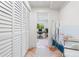 Bright hallway with white shutters and view into home office at 541 Edlee Ln, Longboat Key, FL 34228