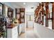 Home bar with wood shelving, a wine rack, and a quartz countertop at 541 Edlee Ln, Longboat Key, FL 34228