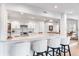 Bright kitchen boasts white cabinets, quartz counters, and an island with seating at 541 Edlee Ln, Longboat Key, FL 34228