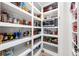 Well-organized pantry with ample shelving for food storage and a microwave at 541 Edlee Ln, Longboat Key, FL 34228