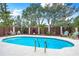 Relaxing kidney-shaped pool with lounge chairs at 541 Edlee Ln, Longboat Key, FL 34228