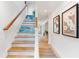 Wooden staircase with ocean-themed wall covering at 541 Edlee Ln, Longboat Key, FL 34228