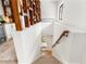 Wooden staircase leading downstairs with a wood and metal railing at 541 Edlee Ln, Longboat Key, FL 34228