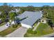 Aerial view of a house with a grey roof and landscaping at 5532 Country Club Way, Sarasota, FL 34243