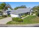 Aerial view showcasing a single-story house with a gray roof, driveway and landscaping at 5532 Country Club Way, Sarasota, FL 34243