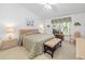 Main bedroom with king-size bed and sitting area at 5532 Country Club Way, Sarasota, FL 34243