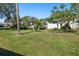 Expansive green space with palm trees and partial pool view at 5532 Country Club Way, Sarasota, FL 34243