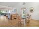 Open dining area with glass-top table and chairs, overlooking living room at 5532 Country Club Way, Sarasota, FL 34243