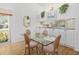 Bright dining area with glass table, chairs, and adjacent kitchen at 5532 Country Club Way, Sarasota, FL 34243