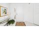 Inviting entryway with a glass-top console table, potted plant, and neutral color scheme at 5532 Country Club Way, Sarasota, FL 34243