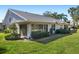 Rear exterior view showcasing a home with a large window and grassy yard at 5532 Country Club Way, Sarasota, FL 34243