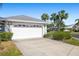 White garage door with landscaping at 5532 Country Club Way, Sarasota, FL 34243