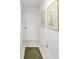 Clean hallway with tile floor and framed artwork at 5532 Country Club Way, Sarasota, FL 34243