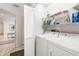 Bright laundry room with washer, dryer, and shelving at 5532 Country Club Way, Sarasota, FL 34243