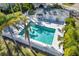 Community pool with lounge chairs and palm trees at 5532 Country Club Way, Sarasota, FL 34243