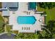 Aerial view of community pool, lounge chairs, and clubhouse at 5532 Country Club Way, Sarasota, FL 34243